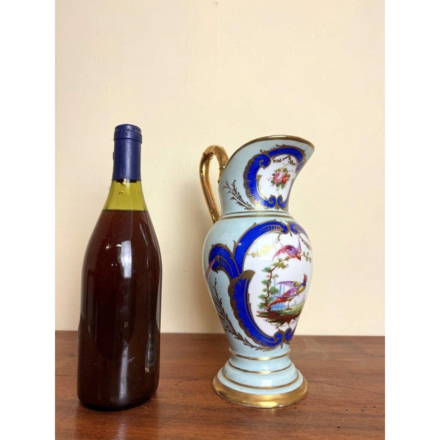 Saxony? Large blue teapot or ewer, Empire period, with gilt decoration resting on a ringed and flared base Hand-painted...