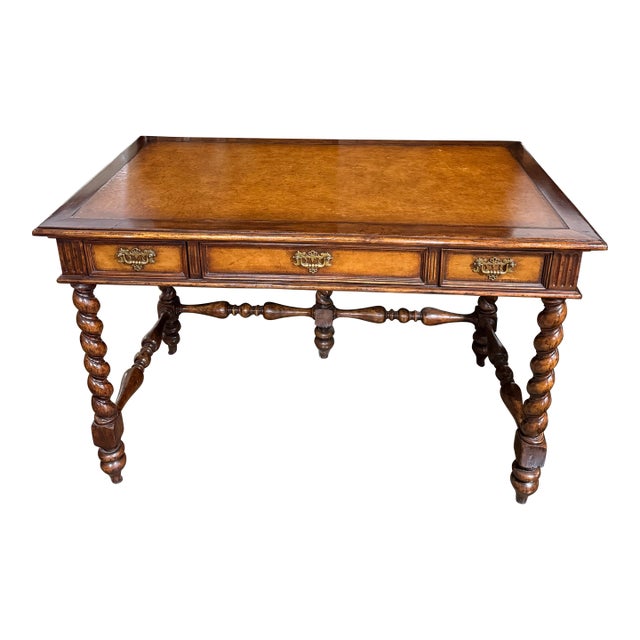 A beautiful English imported writing desk featuring dark wood, barely twist legs and stretchers with a leather. Brass...