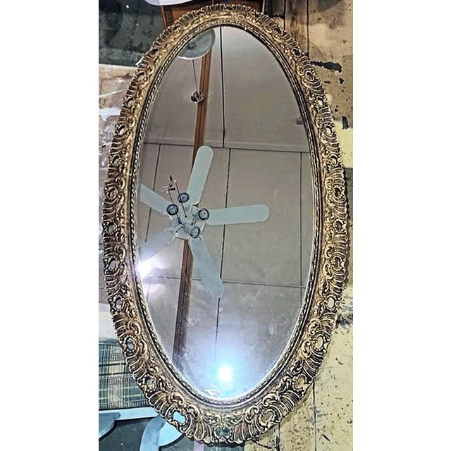 Late 19c gilt and pierced carved wood framed oval wall mirror, wide and narrow or tall and wide.