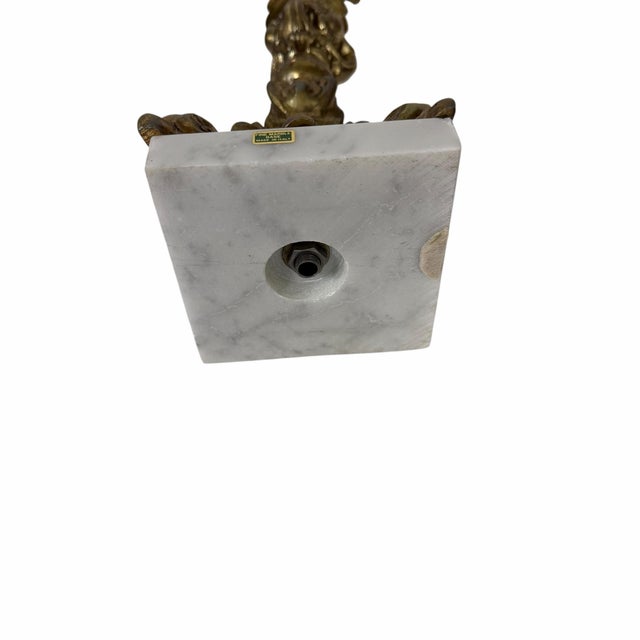 This Italian made vintage Hollywood Regency-style scale features an ornate brass structure supported by a marble base. It...