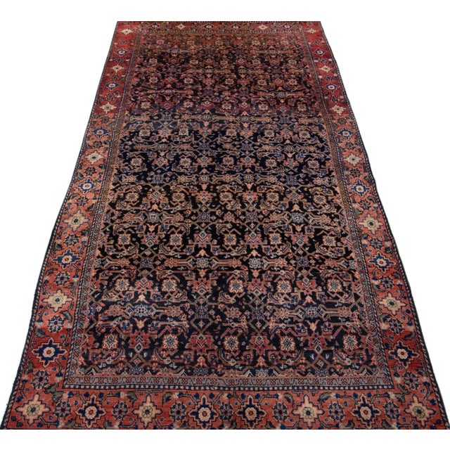 Beautiful vintage Persian Hamadan hand-knotted wool rug with a red color field. This piece has a red frame and multicolor...