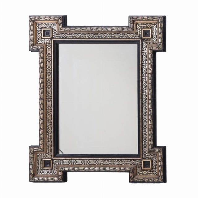 This elegant frame with projecting corners surrounding a rectangular mirror will be a perfect accent on your entry wall.