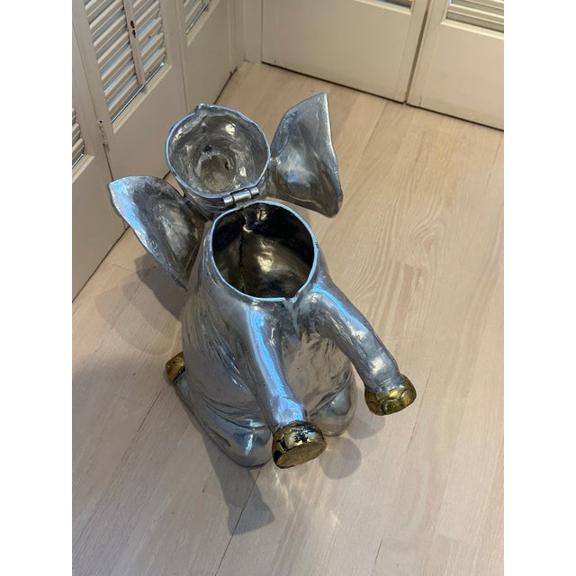 This wonderful hand-crafted polished aluminum ice bucket is in the shape of an elephant (w/brass feet & tusks) and opens...