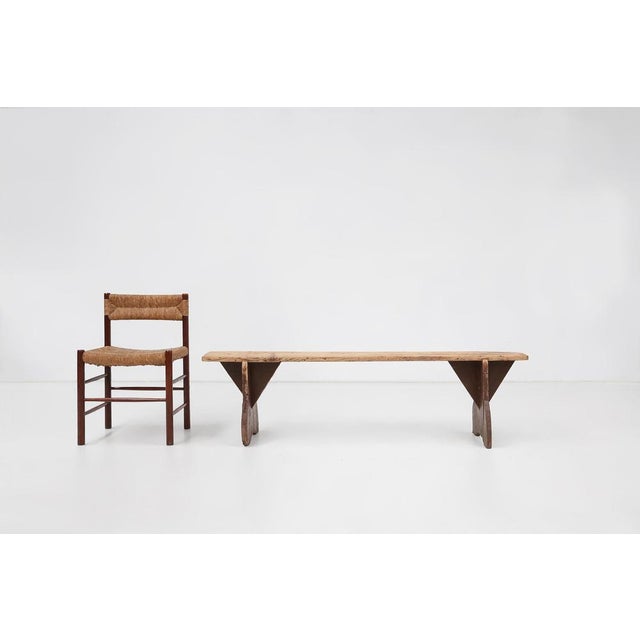A beautifully authentic example of late‑19th‑century French provincial craftsmanship, this rustic wooden bench from around...