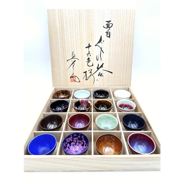 This exceptional set of 16 handcrafted sake cups (guinomi) represents the refined artistry of Arita porcelain, one of...