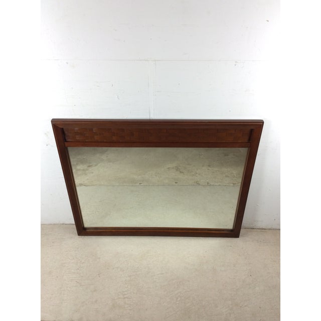 This mid century modern mirror features hardwood frame, original walnut finish, unique basket weave style detailing on the...