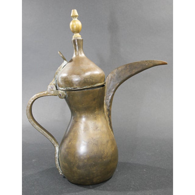 Middle Eastern traditional Arabian brass Dallah coffee pot. Coffee pot hand-hammered and chased copper with riveted brass...