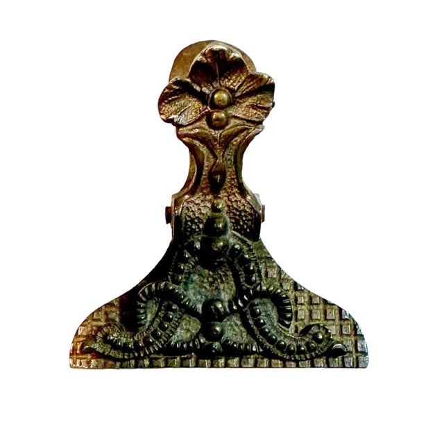 An 1880s English, Victorian very heavy brass clip for papers and objects. A true collectors piece. Can be hung or laid flat.