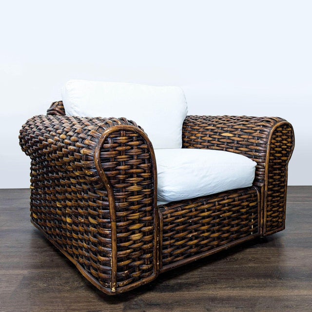 This Ralph Lauren lounge chair features a sturdy woven rattan frame with a rich brown finish. The chair includes soft...