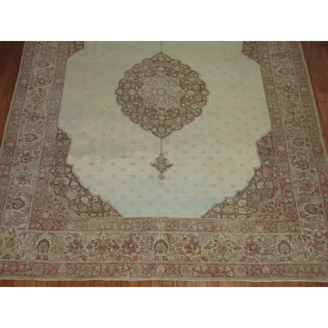 Late 19th century Persian Tabriz rug with a Classic medallion and border on an icy blue field.
