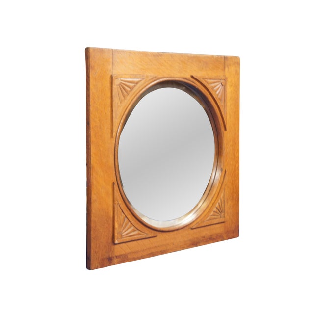 Late Victorian Antique round beveled glass wall mirror in a square oak frame with fan / sun ray carved corners. This piece...