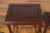 A set of three vintage Chinese rosewood nesting side tables from the mid-20th century with dark reddish brown patina,...