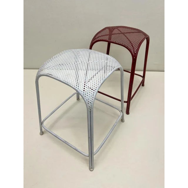 2 metal stools in the industrial style with peforated seat. Dating is around the 1980s Originating from the Netherlands...