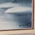 This vintage oil painting by artist BD Pollard depicts a charming snow-covered cabin with stream, trees, and water in...