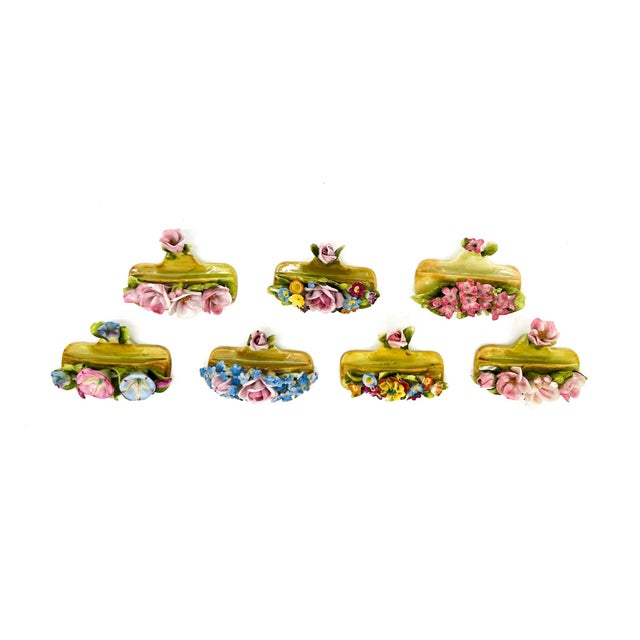 Gorgeous set of seven antique Dresden porcelain place card holders, each heavily decorated with delicate hand-applied...