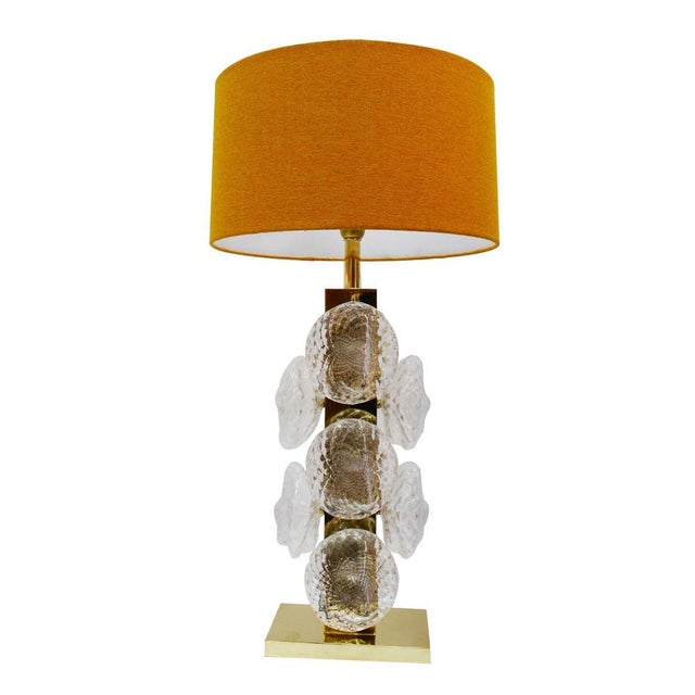 Pair of table lamps made with a rectangular brass structure and blown Murano glass pieces. Every piece design of LA Studio...