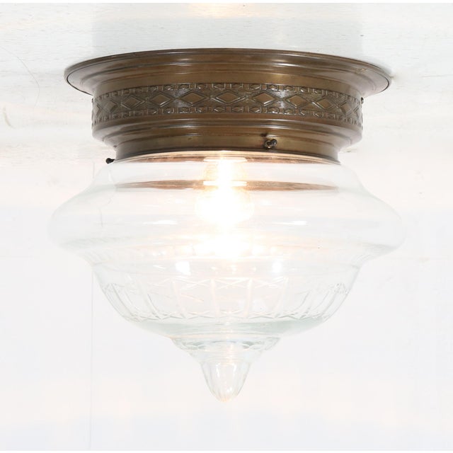 Stunning Art Nouveau flush mount ceiling light. Striking French design from the 1900s. Original patinated brass frame with...