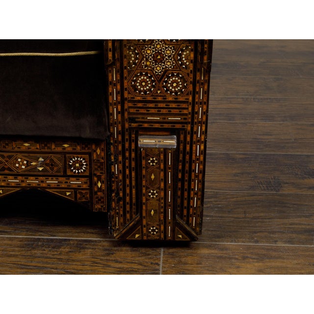An Moroccan club chair from circa 1900 with abundant geometric bone inlay and custom cushion. This Moroccan club chair,...