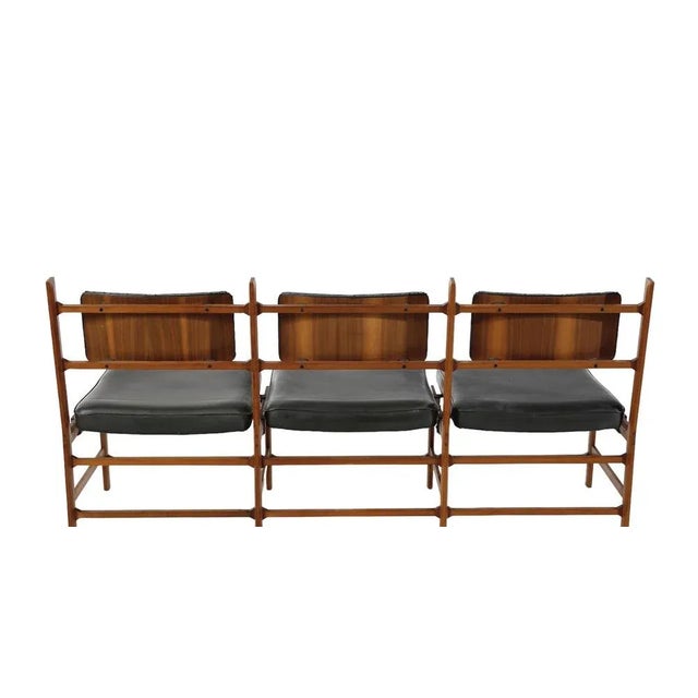 Two two- and three-seater wooden sofas with seats and backs in padded imitation leather and metal. Three-seater model...