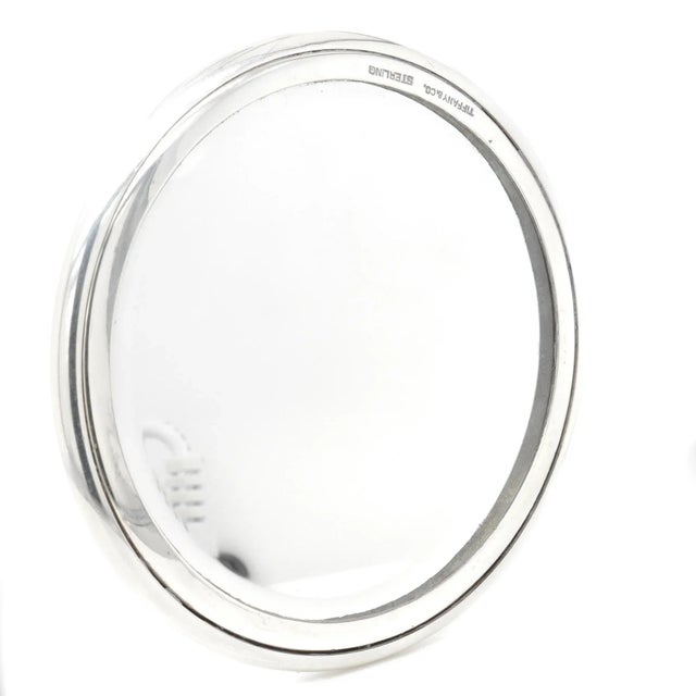 A fine antique silver hand mirror. In sterling silver. By Tiffany & Co. Marked to the rim for Tiffany & Co. / Sterling....