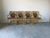 Elegant set of four McGuire-style dining armchairs featuring bamboo frames with signature leather-wrapped joints. Their...