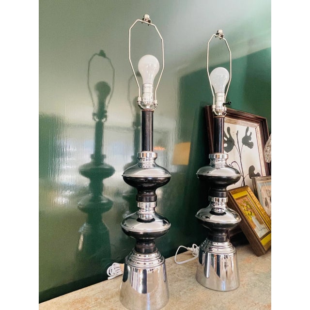 A Pair of Vintage chrome and black stacked lamps. Great form and shape. Height is 31" to top of Harp Rewired Kitty not...