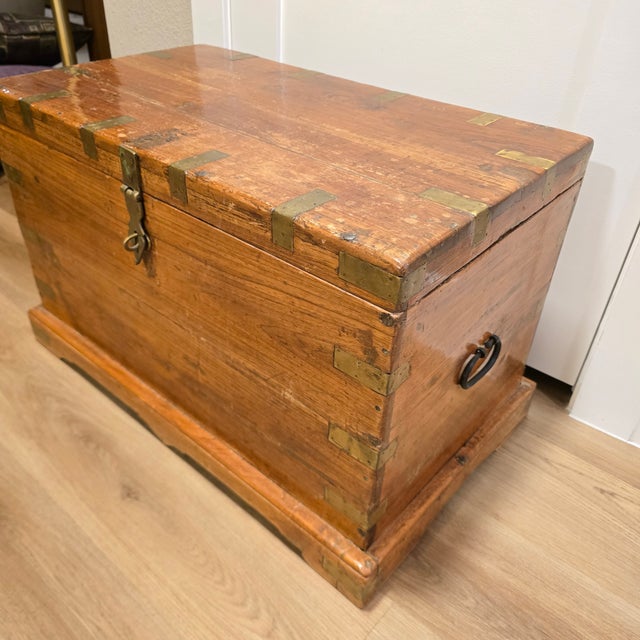 Imported from India by Malabar Coast Living, campaign wood trunk with brass straps, hand-forged iron handles, and a front-...