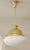 Art Deco pendant lamp, circa 1920. Dish-shaped body suspended from a brass tube. White opal glass shade. The lamp has been...