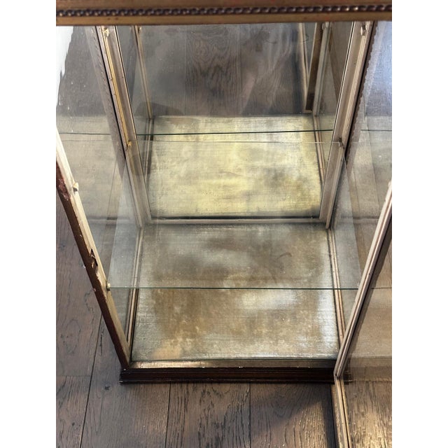 Louis XVI style display cabinet in wood and glass, dating from the 19th century. It features a fully glazed structure...