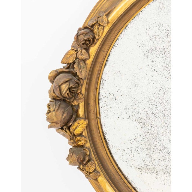 Gilded Age Rose Motif Gilt Composition Oval Beveled Glass Mirror. Mirror plate: 25.5" H x 39.5" W; 33" H x 47" W x 5" D....