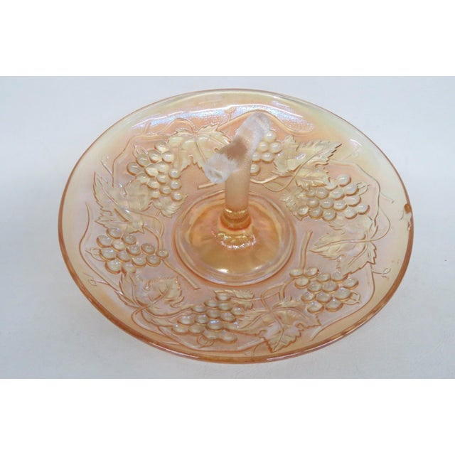 This charming bowl is made of carnival glass. This lovely bowl has a wonderful style; it features a classically rounded...
