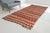 This is a vintage Turkish Oushak rug from the Mid 20th Century. The piece was hand-knotted.