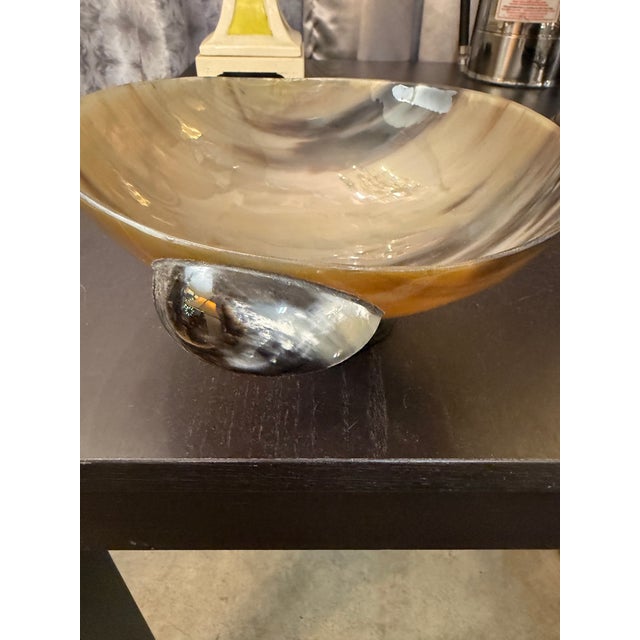 Exquisite hand carved horn bowl. Matching carved bone handles and base complete the design and elevate this decorative...