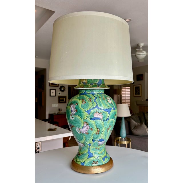 Single Chinese porcelain vintage porcelain lidded ginger jar table lamp, featuring a vibrant green lotus flower and leaf...