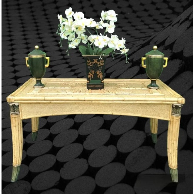 A large wonderful wicker and bamboo Coastal regency carved palm tree top dining table or desk. The table features 2 large...