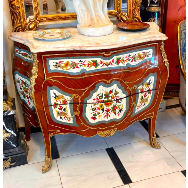 Elevate your interior with this breathtaking French Louis XV Bombe Dresser, a masterpiece of timeless European...