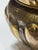 the large hand-hammered vessel with exaggerated everted neck above a tapering lobed body with diaper pattern at the shoulder