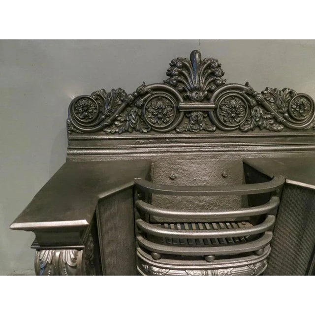 A finely cast hob grate from the early 19th century, in the manner of George Bullock. The scrolled Acanthus leaf console...