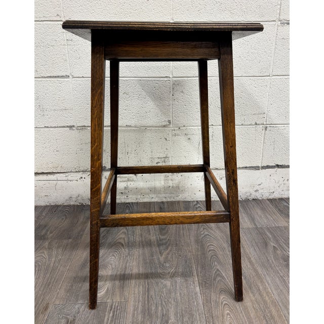 This is a beautiful antique Arts & Crafts / Mission-style oak side table featuring a classic rectilinear design, richly...