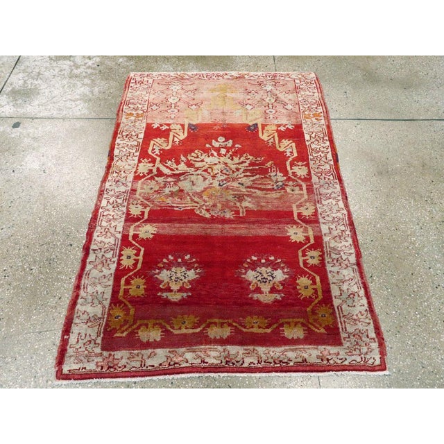 This early 20th century Turkish Oushak rug, measuring 3' 3" x 4' 10", features a vivid palette and bold aesthetic...
