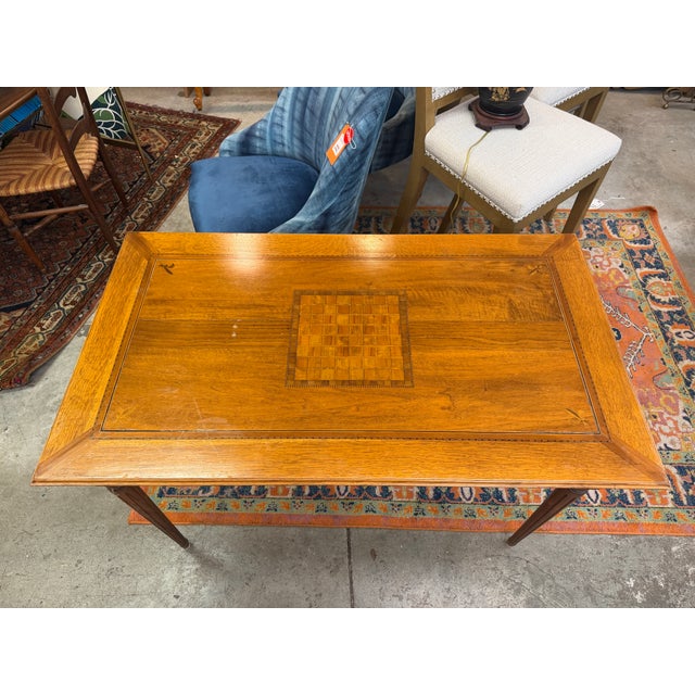 This vintage English game table with a rectangular top showcases a beautiful, tight oak grain structure finished in a...