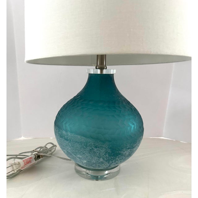 Stunning art glass lamp on crystal base with crystal shade. New, never used. White linen shade included . Measures 23” h x...