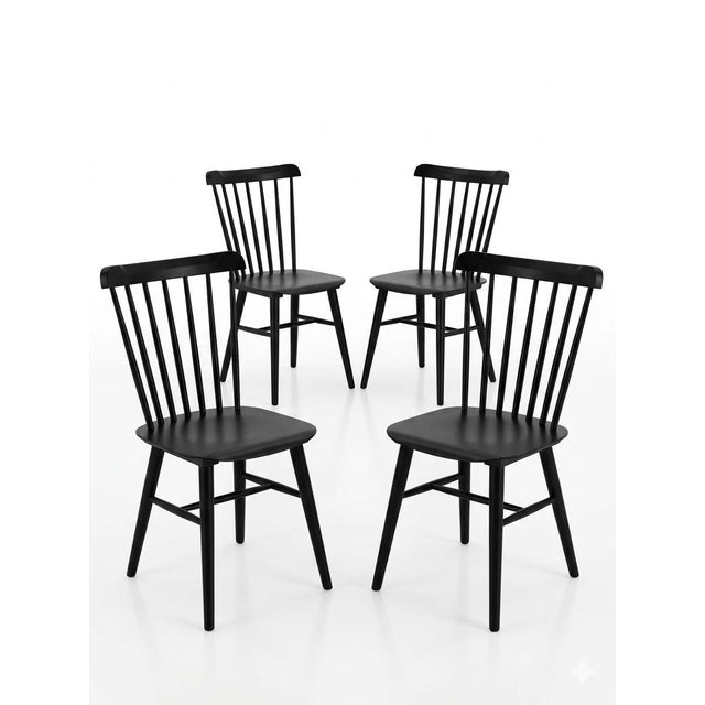 A crisp set of four Williams Sonoma dining chairs in a matte black finish, featuring a refined spindle-back silhouette...