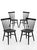 A crisp set of four Williams Sonoma dining chairs in a matte black finish, featuring a refined spindle-back silhouette...
