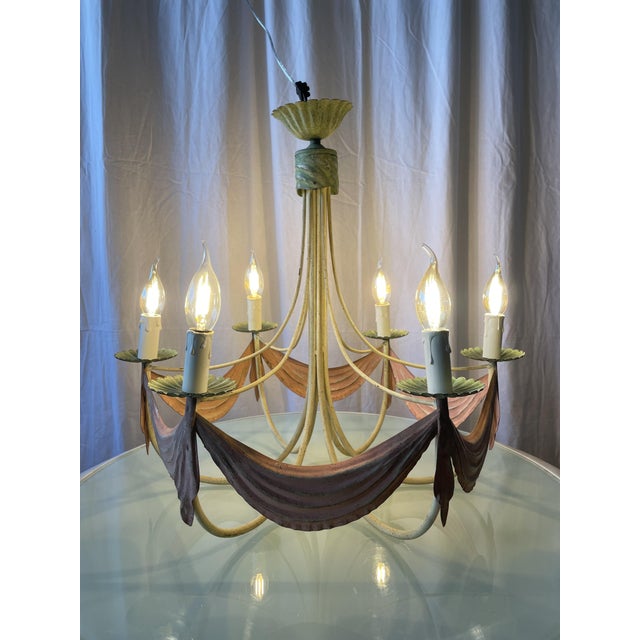 Six-arm chandelier in enameled sheet metal, mid-20th century. Romantic and theatrical style. Whimsical structure composed...