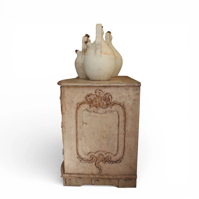 This antique painted chest reflects the elegance and playful ornamentation characteristic of the period. Crafted from...