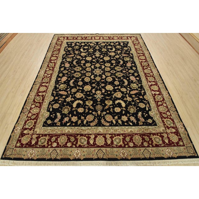 A traditional Tabriz rug, hand-knotted with fine wool and silk highlights on a cotton foundation. This oriental rug...