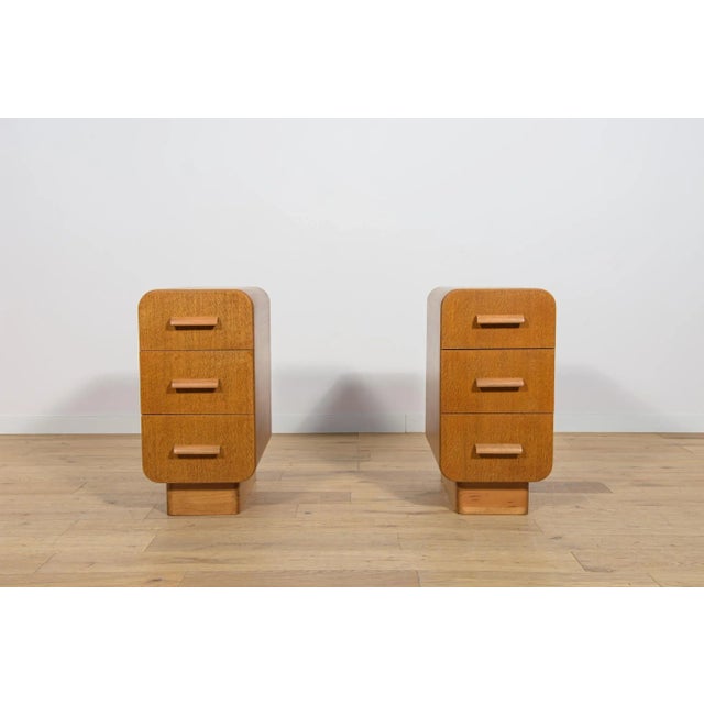 Art Deco nightstands manufactured in Czechoslovakia in the 1950s. The furniture has rounded shapes, giving it a unique...