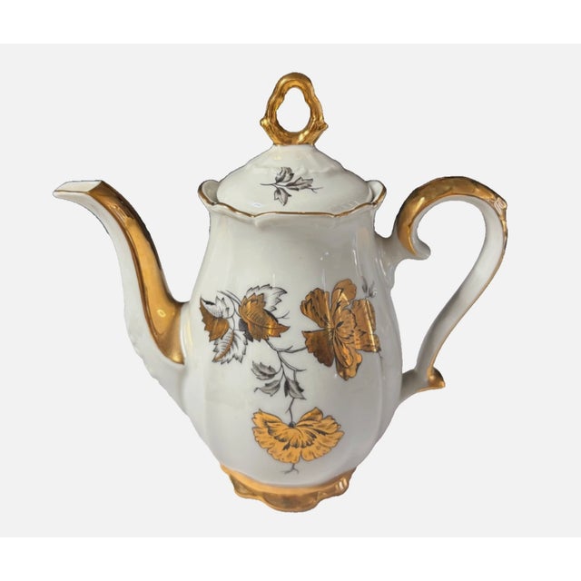 This Porcelain Coffee Service by Bareuther Waldsassen Bavaria is a luxurious set featuring a 24k gold rim and ornament...