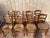 Set of eight French rustic-style dining chairs, 20th century, made of fruitwood with a warm patina. Ladder-back design...